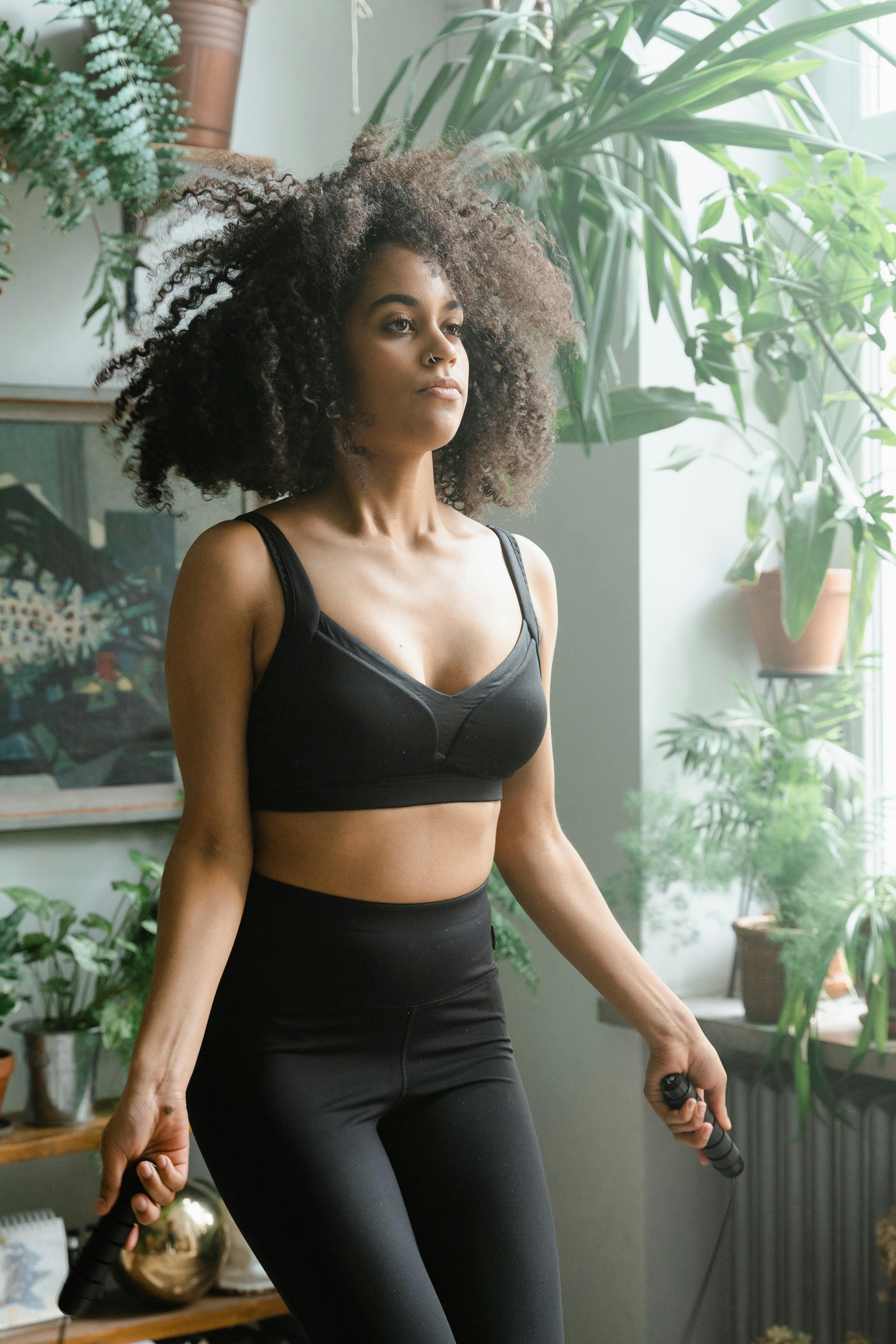 Woman training at home with jump rope